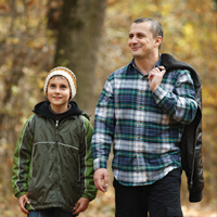 Man and son walking in the woods
